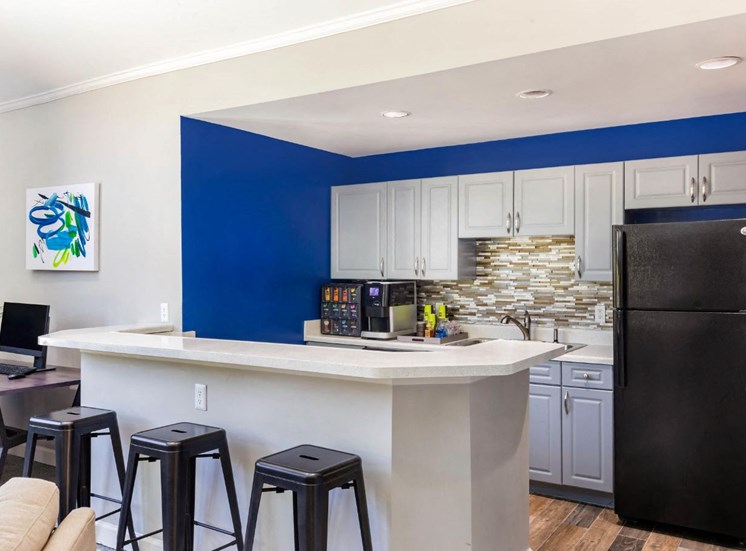 Clubhouse Kitchen Area with Breakfast Bar and Blue Accent Wall
